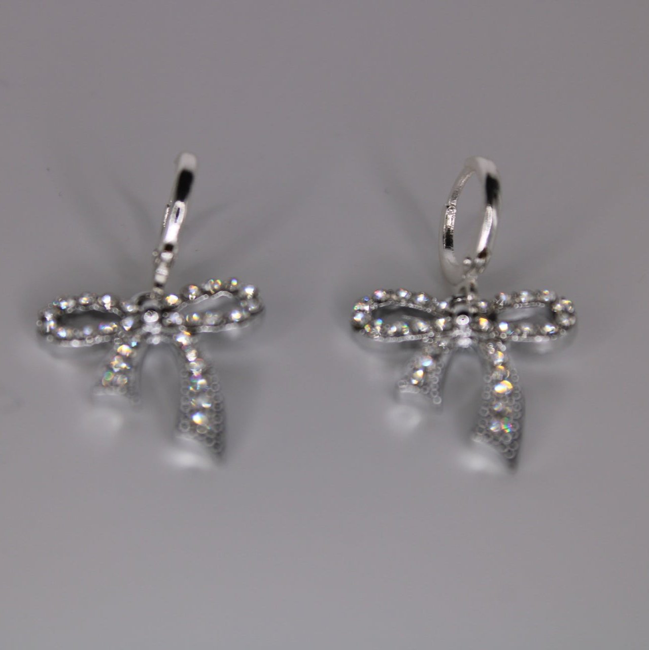 silver glimmer bow earrings