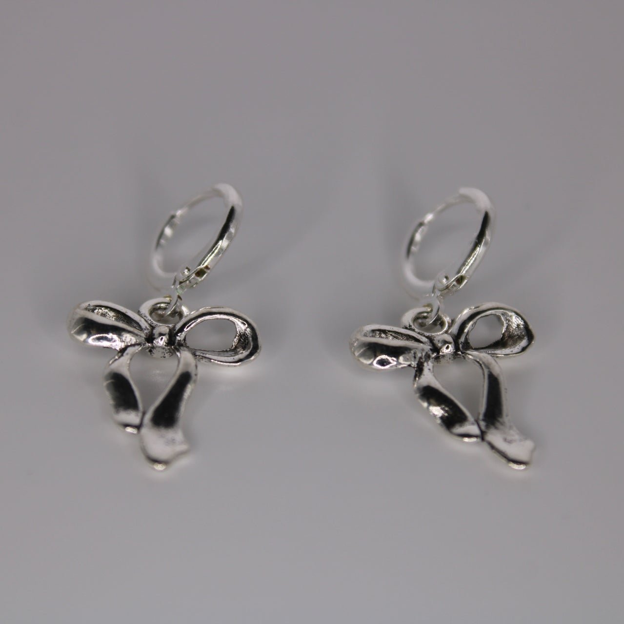 silver glow bow earrings